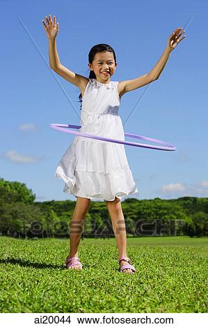 Girl in park playing with hoola hoop View Large Photo Image Picture - Girl in park playing with hoola hoop. Fotosearch