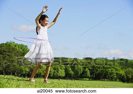 Girl in park using hoola hoop View Large Photo Image Stock Photography - Girl in park using hoola hoop. Fotosearch