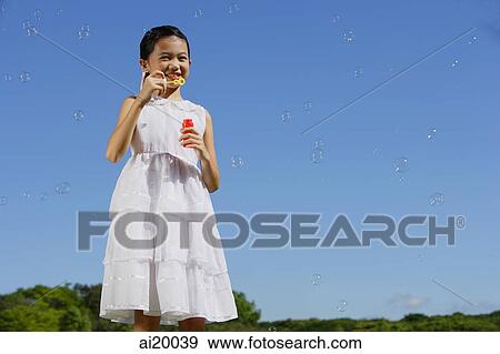 Girl in white dress, blowing bubbles View Large Photo Image Stock Photo - Girl in white dress, blowing bubbles. Fotosearch