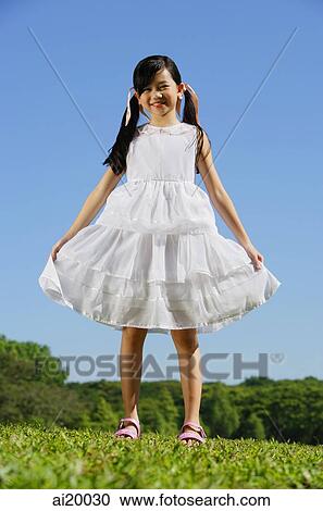 Girl in white dress, smiling at camera View Large Photo Image Stock Image - Girl in white dress, smiling at camera. Fotosearch
