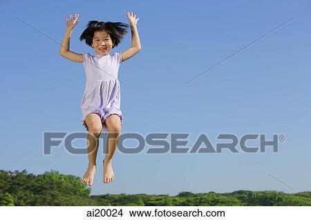Girl jumping in mid air, smiling View Large Photo Image Picture - Girl jumping in mid air, smiling. Fotosearch