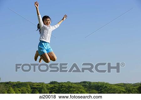 Girl jumping in mid air View Large Photo Image Stock Photo - Girl jumping in mid air. Fotosearch
