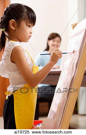 Girl painting on easel, mother in the background View Large Photo Image Stock Photography - Girl painting on easel, mother in the background. Fotosearch
