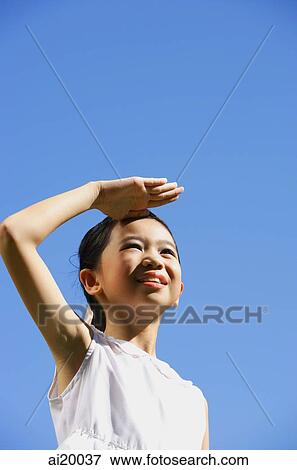 Girl shielding eyes, looking away View Large Photo Image Stock Photo - Girl shielding eyes, looking away. Fotosearch