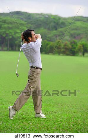 Stock Image - Golfer playing golf. Fotosearch