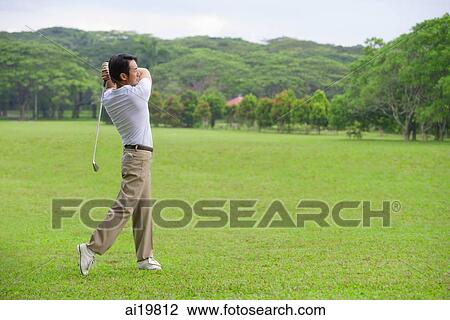 Golfer teeing off View Large Photo Image Stock Image - Golfer teeing off. Fotosearch