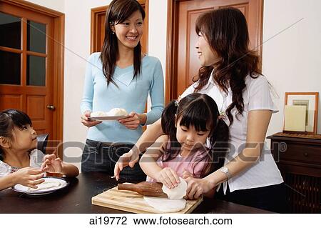 Grandmother with daughter and two granddaughters at home, making dough View Large Photo Image Stock Image - Grandmother with daughter and two granddaughters at home, making dough. Fotosearch