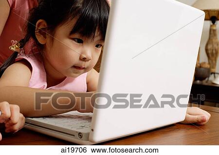 Little girl using laptop View Large Photo Image Stock Photograph - Little girl using laptop. Fotosearch