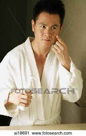 Man applying moisturizer on face View Large Photo Image Stock Image - Man applying moisturizer on face. Fotosearch