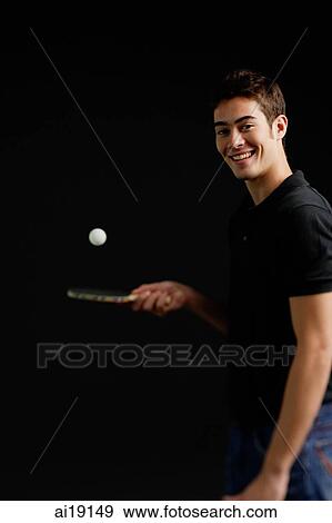 Stock Photo - Man bouncing ball on table tennis racket. Fotosearch