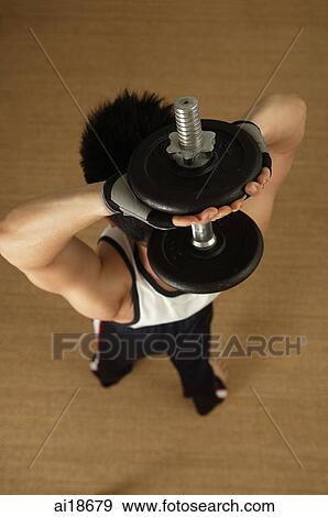 Man carrying barbell over his head, high angle view View Large Photo Image Stock Photo - Man carrying barbell over his head, high angle view. Fotosearch