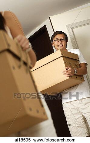 Man carrying box, smiling at camera View Large Photo Image Stock Photography - Man carrying box, smiling at camera. Fotosearch