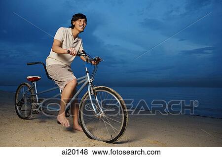 Stock Photo - Man cycling with tandem bicycle. Fotosearch
