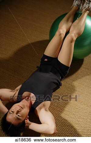Stock Photograph - Man doing sit ups with fitness ball. Fotosearch