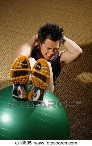 Man doing sit ups with fitness ball View Large Photo Image Stock Photography - Man doing sit ups with fitness ball. Fotosearch