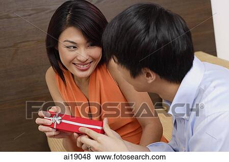 Man giving woman present View Large Photo Image Stock Photo - Man giving woman present. Fotosearch