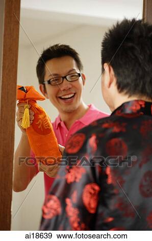 Man greeting visitor at door View Large Photo Image Stock Photo - Man greeting visitor at door. Fotosearch