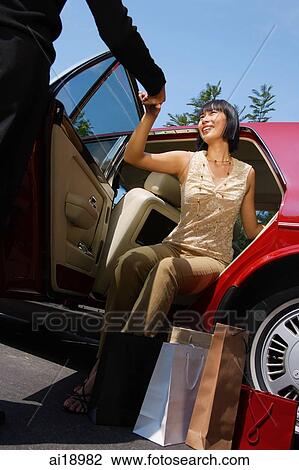 Man helping woman out of car View Large Photo Image Stock Image - Man helping woman out of car. Fotosearch