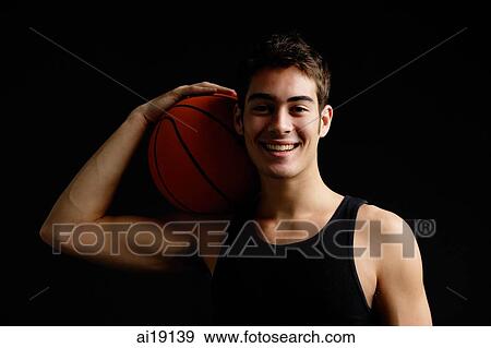 Man holding basketball on shoulder, smiling at camera View Large Photo Image Stock Photo - Man holding basketball on shoulder, smiling at camera. Fotosearch