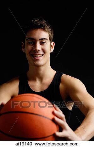 Man holding basketball towards camera, smiling View Large Photo Image Stock Image - Man holding basketball towards camera, smiling. Fotosearch