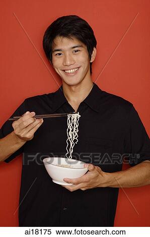 Man holding bowl of noodles View Large Photo Image Stock Photography - Man holding bowl of noodles. Fotosearch