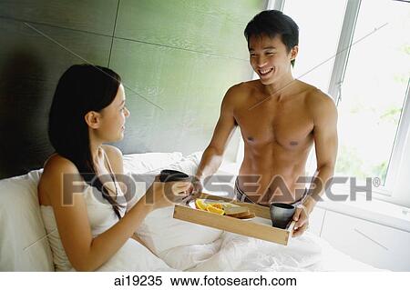 Man holding breakfast tray, woman sitting in bed View Large Photo Image Stock Photography - Man holding breakfast tray, woman sitting in bed. Fotosearch