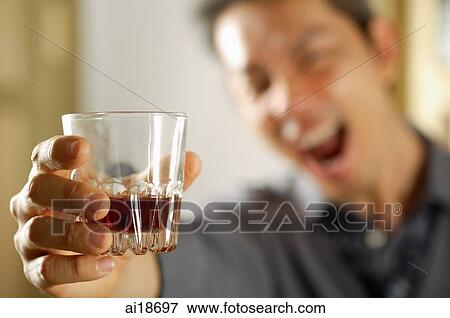 Stock Photo - Man holding drink, selective focus. Fotosearch