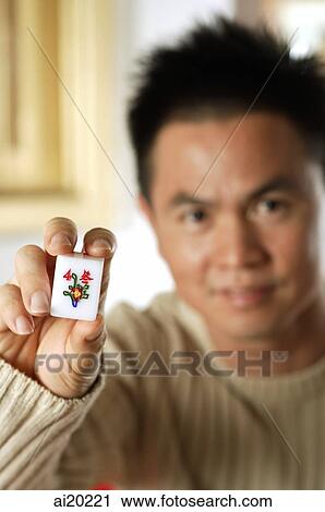Man holding mahjong tile with the Chinese script for Winter View Large Photo Image Stock Image - Man holding mahjong tile with the Chinese script for Winter. Fotosearch
