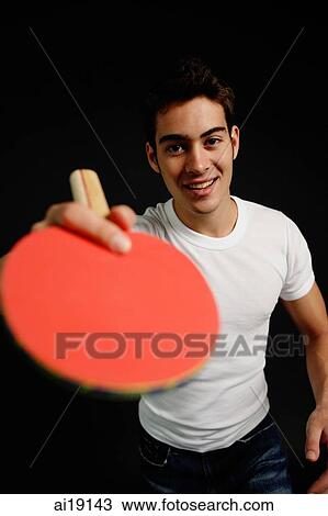 Stock Image - Man holding table tennis racket. Fotosearch