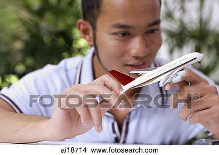 Man holding toy airplane model View Large Photo Image Picture - Man holding toy airplane model. Fotosearch
