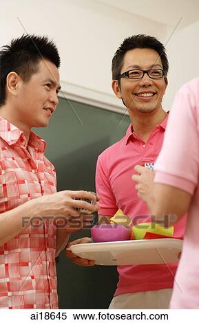Man holding tray, serving guests View Large Photo Image Stock Photography - Man holding tray, serving guests. Fotosearch