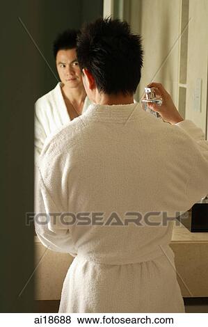 Man in bathrobe, spraying perfume View Large Photo Image Stock Photo - Man in bathrobe, spraying perfume. Fotosearch