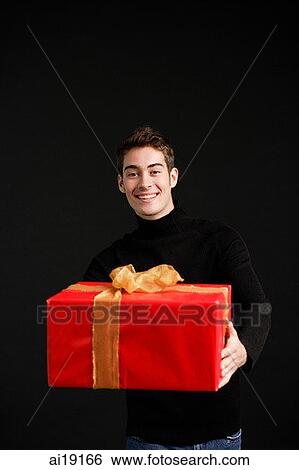 Man in black turtleneck, holding wrapped present View Large Photo Image Stock Photograph - Man in black turtleneck, holding wrapped present. Fotosearch