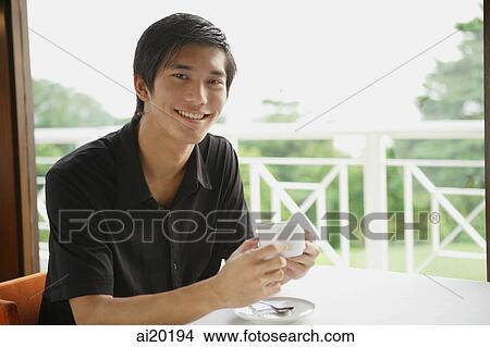 Man in cafe having coffee View Large Photo Image Picture - Man in cafe having coffee. Fotosearch