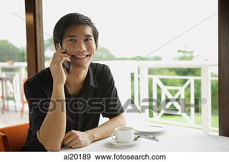 Man in cafe using mobile phone View Large Photo Image Stock Photo - Man in cafe using mobile phone. Fotosearch