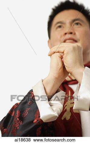 Stock Photo - Man in Chinese costume, hands clasped. Fotosearch