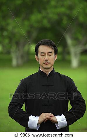 Stock Photography - Man in park, meditating. Fotosearch