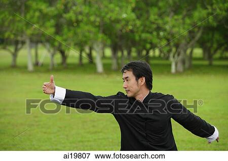 Man in park, practicing tai chi View Large Photo Image Stock Photo - Man in park, practicing tai chi. Fotosearch