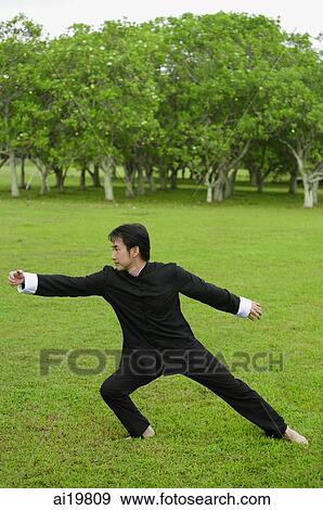 Man in park, practicing tai chi View Large Photo Image Stock Photo - Man in park, practicing tai chi. Fotosearch