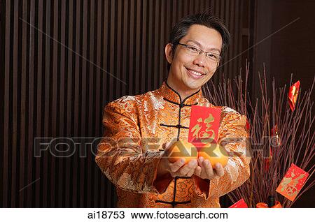 Man in traditional Chinese clothing holding oranges View Large Photo Image Stock Image - Man in traditional Chinese clothing holding oranges. Fotosearch