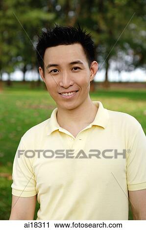 Man in yellow polo shirt smiling at camera View Large Photo Image Stock Image - Man in yellow polo shirt smiling at camera. Fotosearch