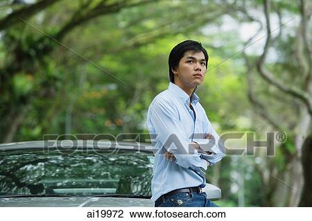 Man leaning on car, arms crossed View Large Photo Image Stock Image - Man leaning on car, arms crossed. Fotosearch