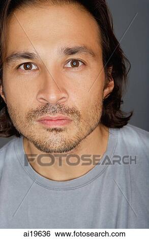 Stock Photograph - Man looking at camera, portrait. Fotosearch