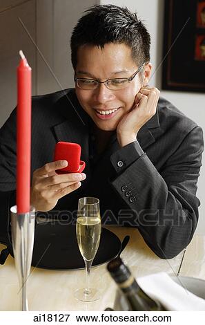 Man looking at ring box, smiling View Large Photo Image Stock Photo - Man looking at ring box, smiling. Fotosearch