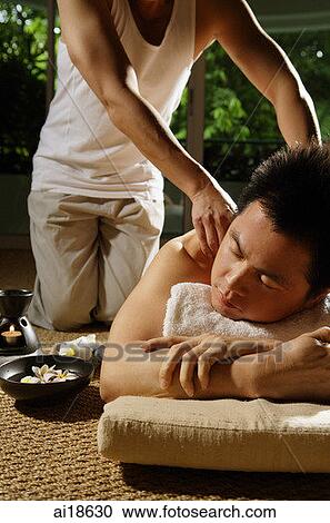 Man lying down being massaged by masseuse View Large Photo Image Stock Image - Man lying down being massaged by masseuse. Fotosearch