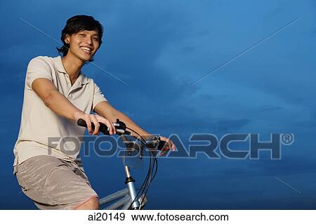 Man on bicycle, smiling at camera View Large Photo Image Stock Photo - Man on bicycle, smiling at camera. Fotosearch
