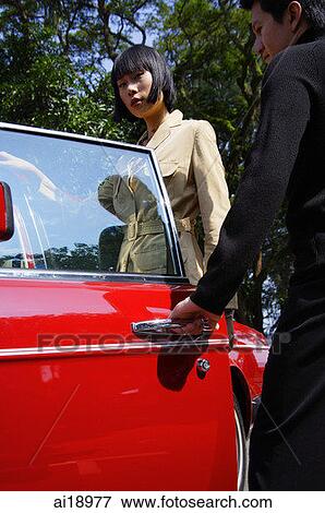 Man opening door of car for woman View Large Photo Image Stock Photo - Man opening door of car for woman. Fotosearch