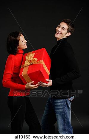 Man passing gift to woman View Large Photo Image Stock Image - Man passing gift to woman. Fotosearch