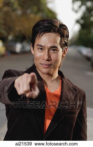 Stock Photo - Man pointing finger at camera. Fotosearch