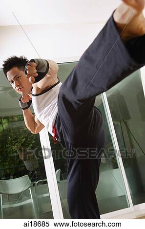Man practicing martial arts, kicking View Large Photo Image Stock Photography - Man practicing martial arts, kicking. Fotosearch